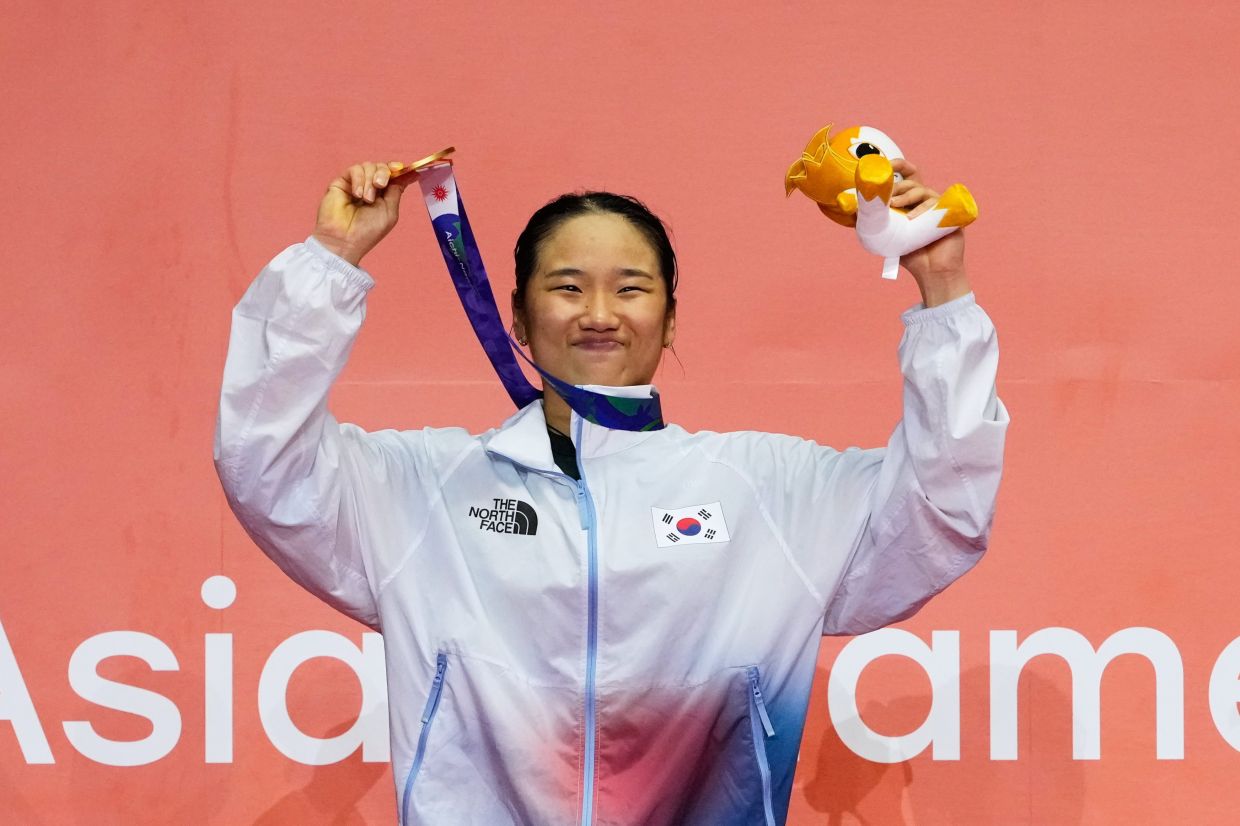 Gold medalist South Korea's An Se-young poses on the podium after winning the women's singles badminton at the Asian Games. - AP