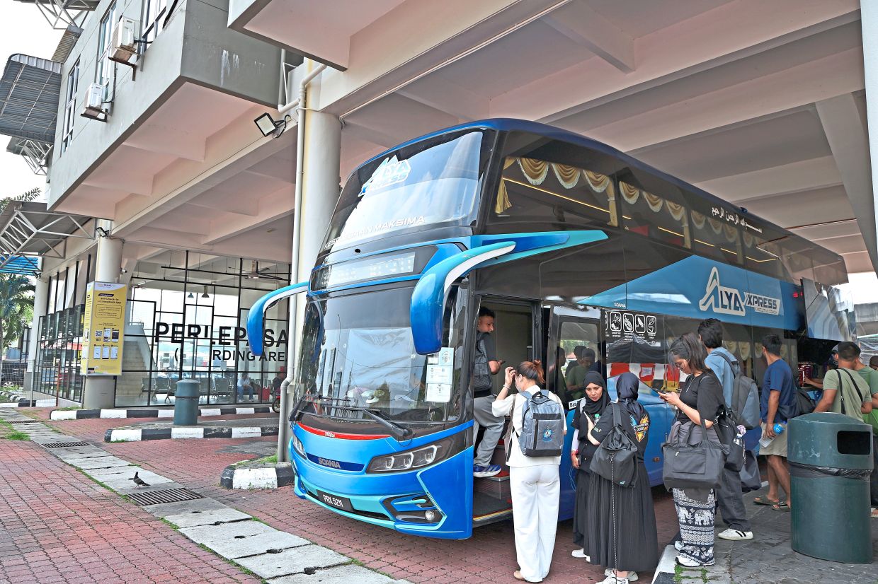 Passengers getting on an express bus at Sungai Nibong Bus Terminal.