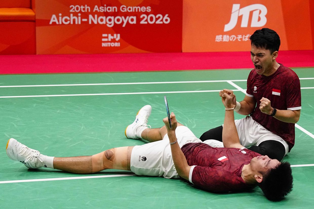 Indonesia’s Daniel Marthin (left) and Leo Rolly celebrate their victory against China’s Liang Weikeng-Wang Chang. – AP/AFP