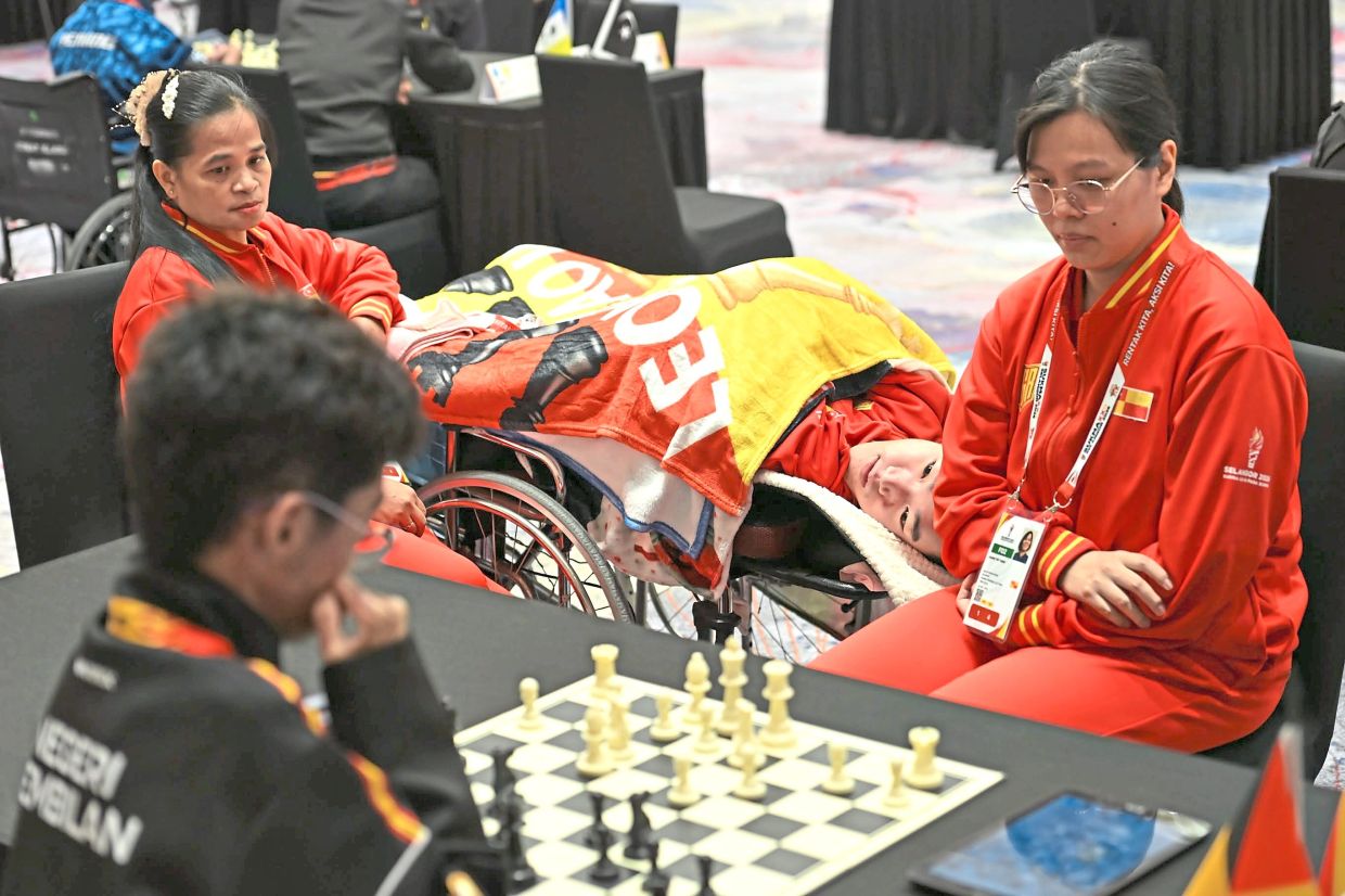 Bed-ridden Selangor para chess player Leong Yao Wen (centre) competing with full focus during the Para Sukma chess competition.