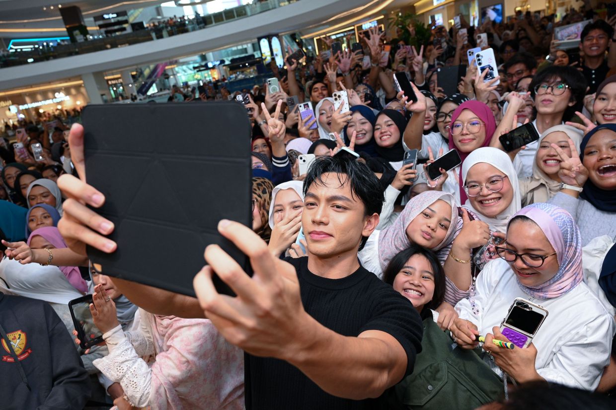 Zarif Ghazzi taking a photo with his fans at an event recently. 