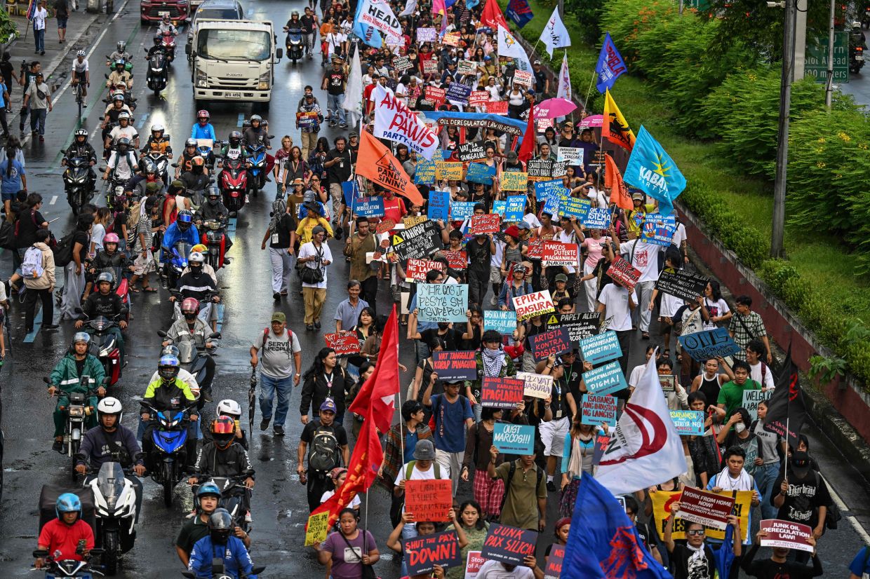 Jeepney drivers and various groups walking along a street to protest against high fuel prices in Manila on Sept 30, 2026. The Philippines has been struggling to deal with soaring fuel costs from the Middle East war, and as an import-dependent country it declared a national energy emergency in March, forcing it to cast an ever-wider net for fuel, including purchases of oil from Russia. - AFP