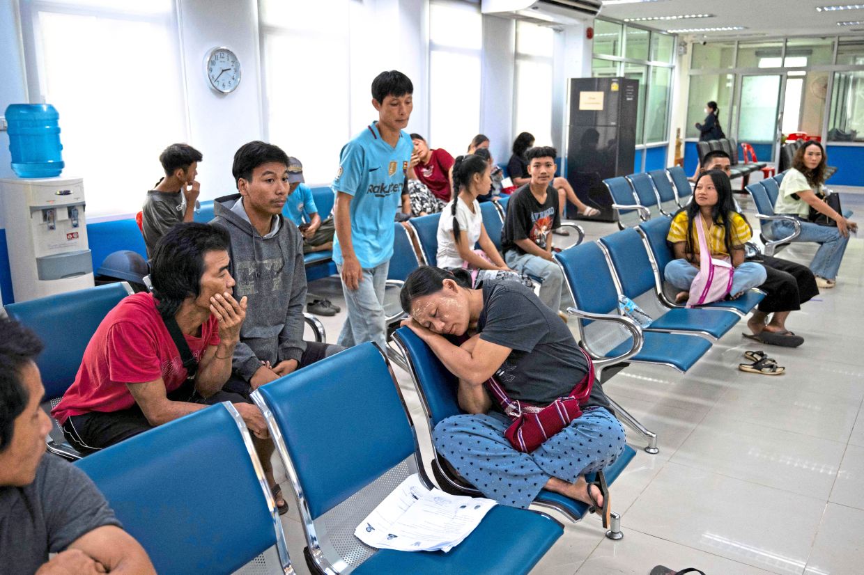 Starting over: Karen refugees from the Mae La refugee camp along the Thai-Myanmar border waiting inside a district office to register for Thai ID cards issued to foreigners granting them permission to work, in Prachinburi province. — AFP