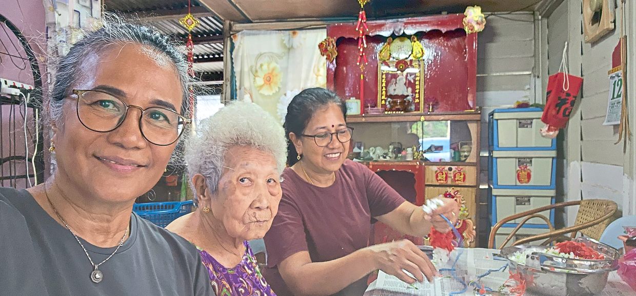 Cheong (centre) with daughters Sautthiary (left) and Thevi, who continue to support their mother’s hobbies.