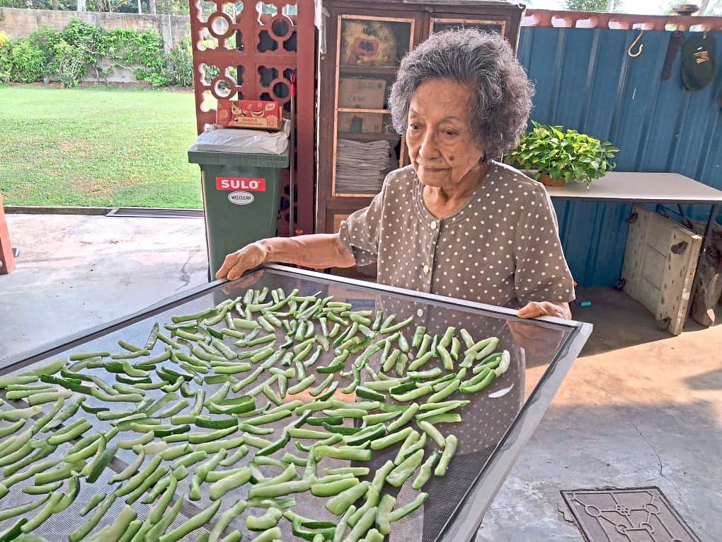Tan sun-dries the vegetables the traditional way to keep her achar Sarawak crunchy.