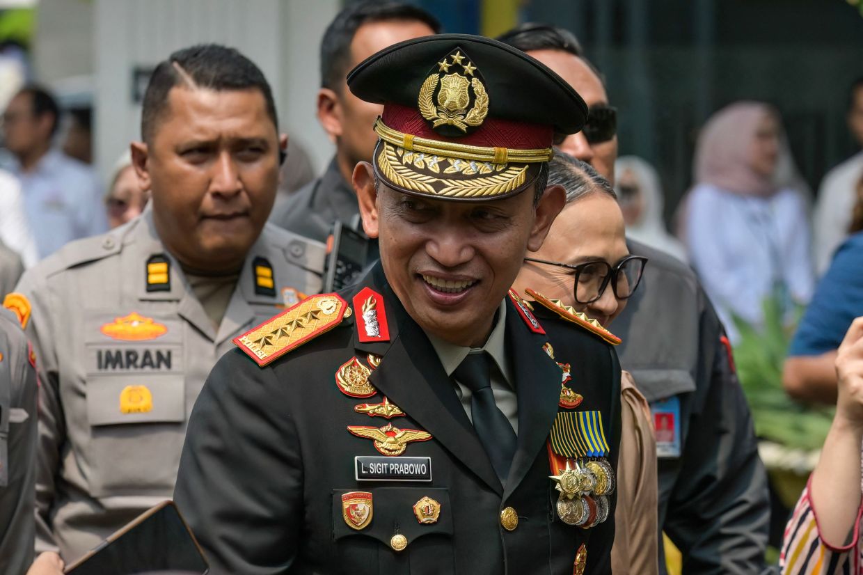 Former Indonesian National Police Chief General Listyo Sigit Prabowo smiling as he arrives at the State Palace in Jakarta on Oct 1, 2026. - AFP