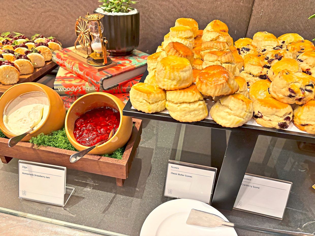 Freshly baked Classic Butter Scones (centre) and Cranberry Scones (right) with accompaniments, presented on platters during the Pink October event.