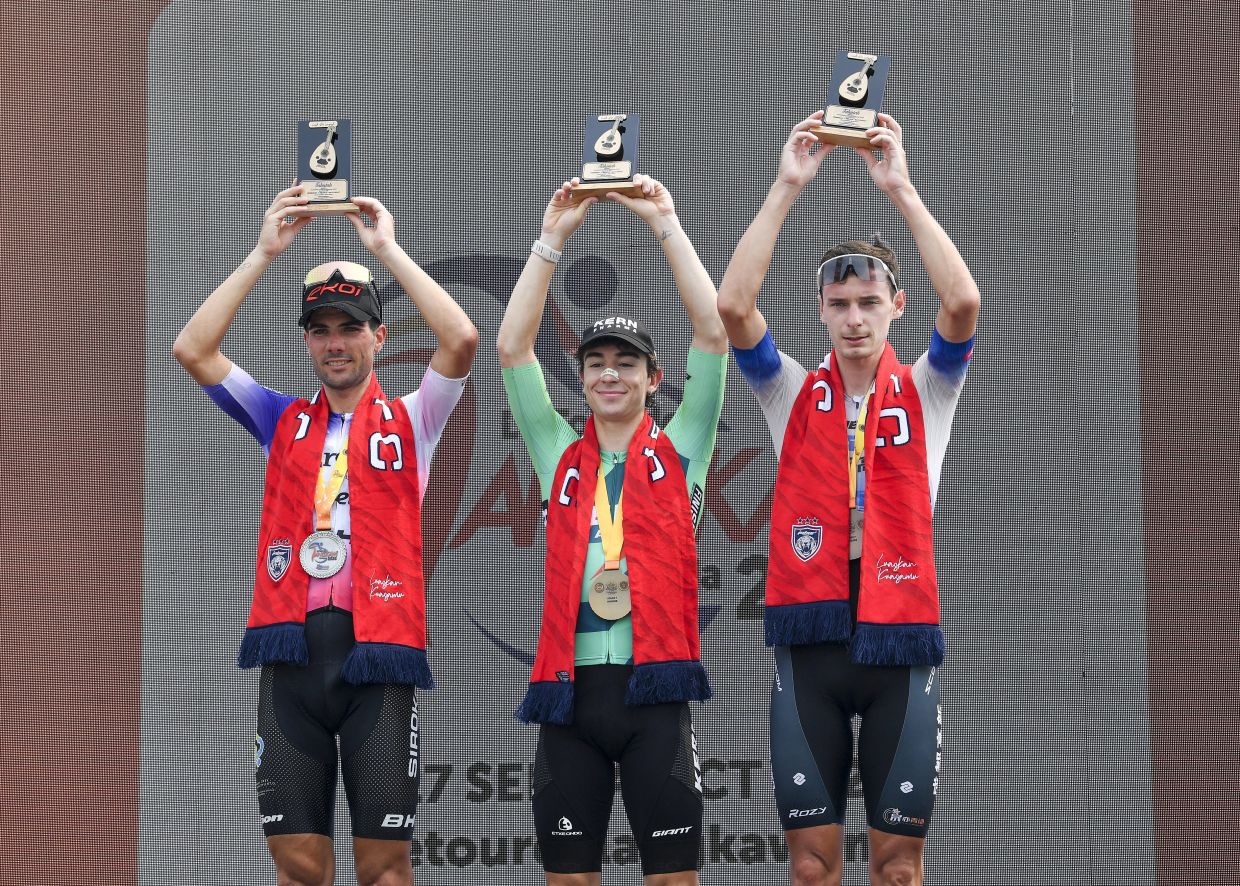 Great run: First place winner Equipo Kern Pharma rider Nil Gimeno Ferrer (centre) together with second place winner Mario Aparicio Munoz (left) of Burgos Burpellet-BH and third place winner Andrei Stepanov of Wheeltop Rotor Chengdu Team with their trophies. — IZZRAFIQ ALIAS/The Star