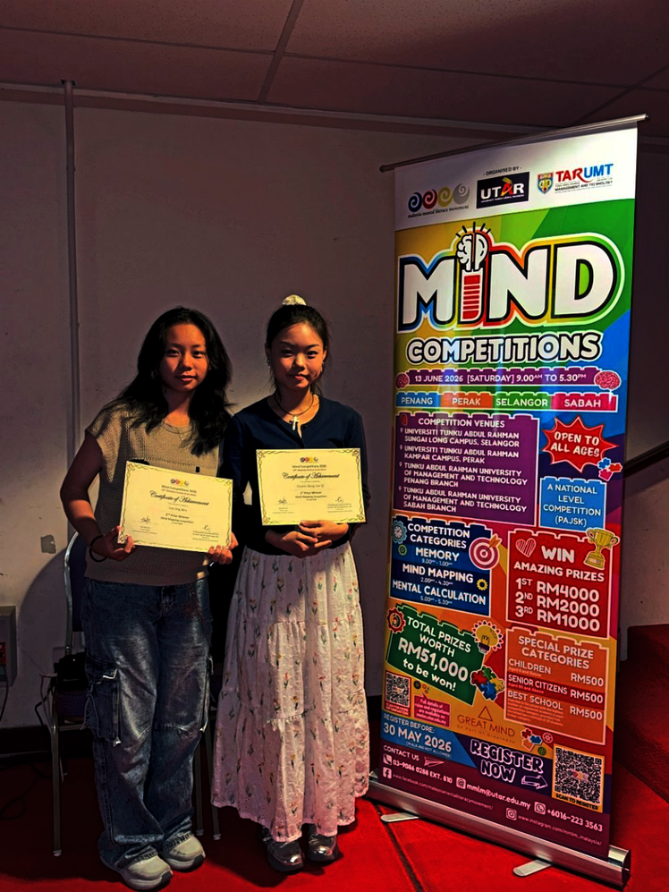 Proud moment: Lee (left) and Dang posing with their certificates after being named winners.