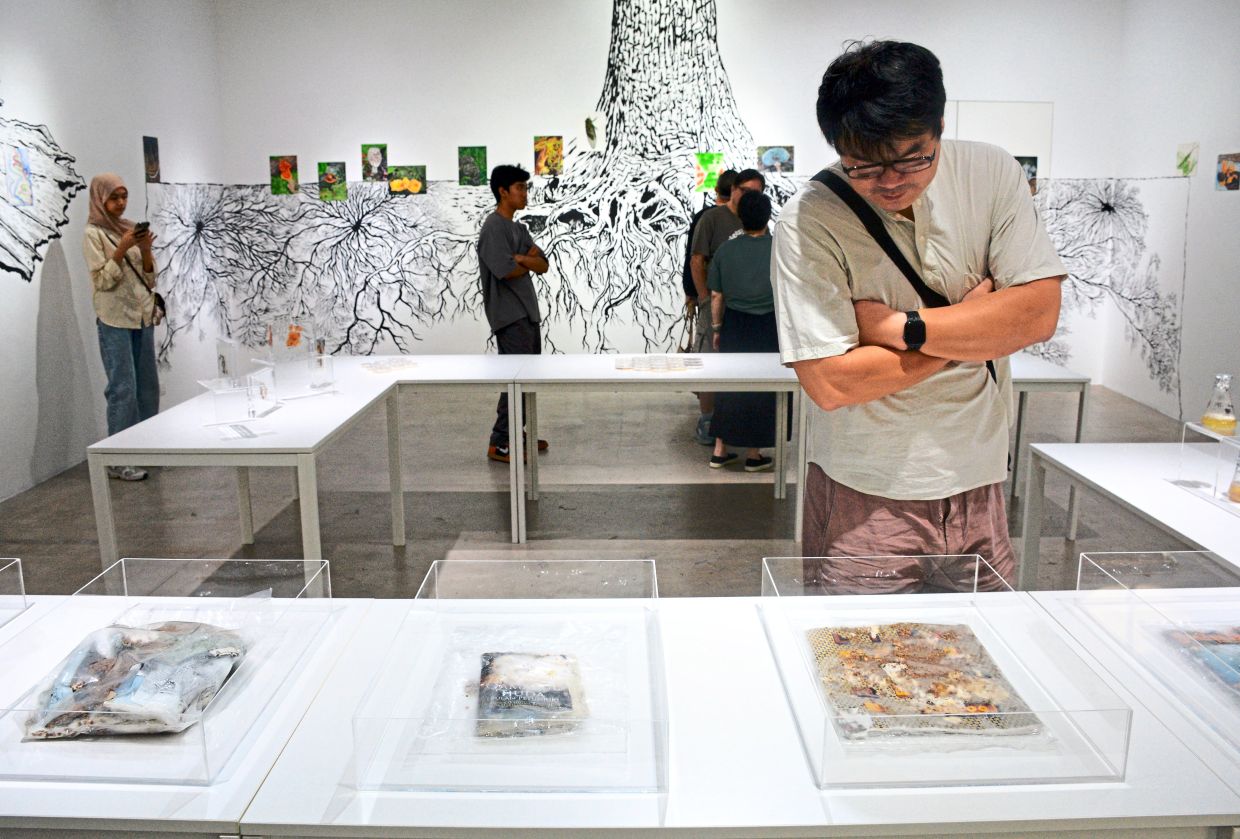 Visitors looking at the installation of tactile mycelium experiments that are part of the 'Fruiting Bodies' exhibition at Blank Canvas in George Town. Photo: Jeremy Tan