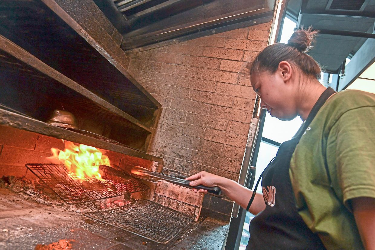 Yew says cooking with charcoal fire requires a keen eye, a good nose and a whole lot of intuition.