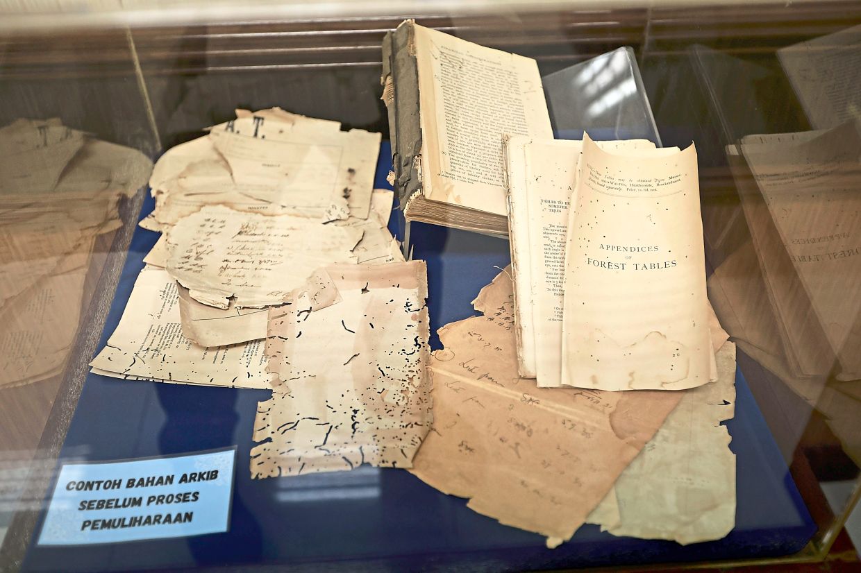 The National Archives of Malaysia display examples of what some items may look like before the restoration process.