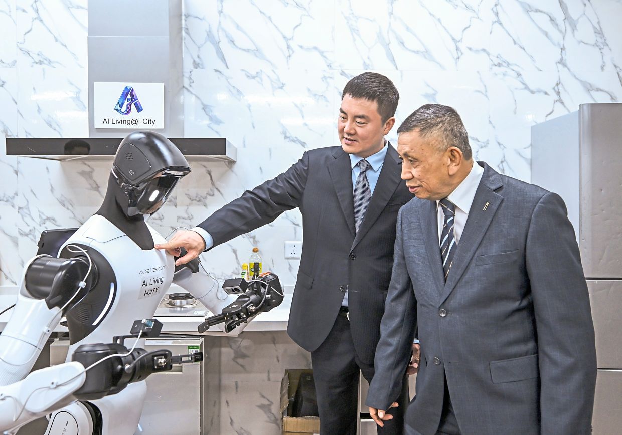 Deng and Lim (right) reviewing the progress of AgiBot’s domestic robotics capabilities for the AI Living @ i-City development.