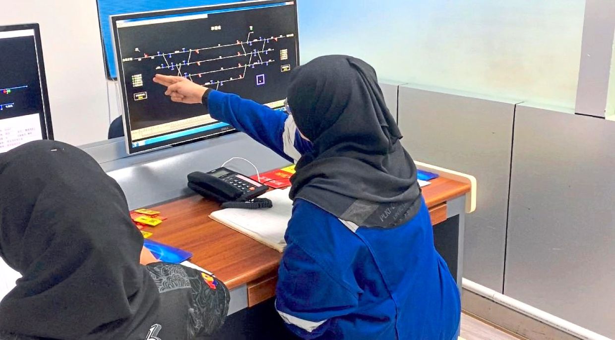 Nureen Syamimi practising the various train operation procedures using the train control system.