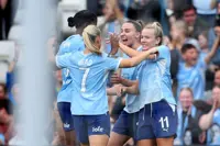 Soccer-Manchester City beat hapless Arsenal 4-2 to stay top of WSL