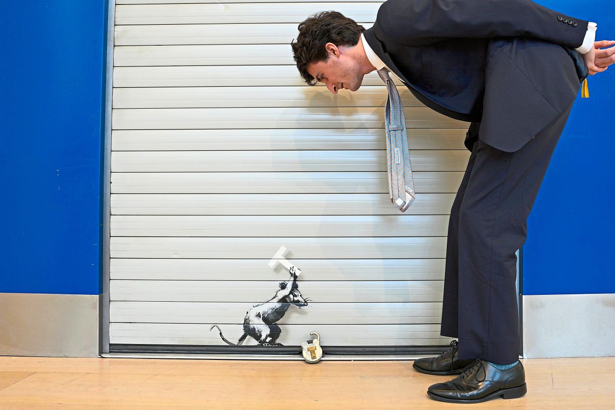 2. Banksy’s ‘Keep Ou T’, estimated at £1.2mil to £1.8mil, is displayed during a preview of Phillips’ Frieze Week Modern & Contemporary Art Auctions in London, United Kingdom. The work appears to reflect the artist’s disdain for Britain’s decision to leave the European Union. — AP