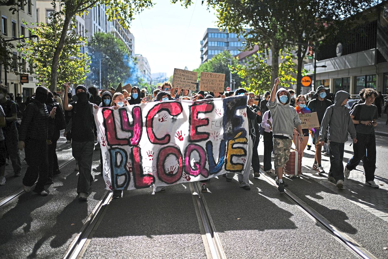 2. Demonstrators holding a banner reading ‘High school blocked’ during student protests in Lyon. The protests began in the Ile-de-France region around Paris before spreading to cities across the country.