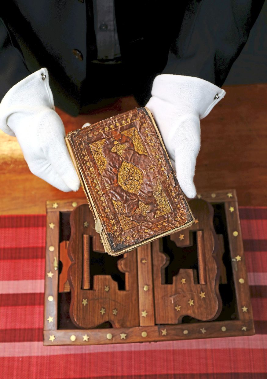 Visitors must wear protective gloves when handling original manuscripts such as this ‘Petua, Azimat, Doa, Mantera’, which is a collection of traditional advice, practices, charms, prayers and incantations used by Malay communities in the past.