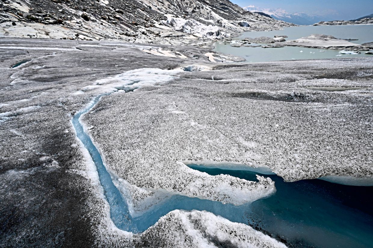 A file photo from 2025 showing water flowing from the melting Rhone Glacier. — AP