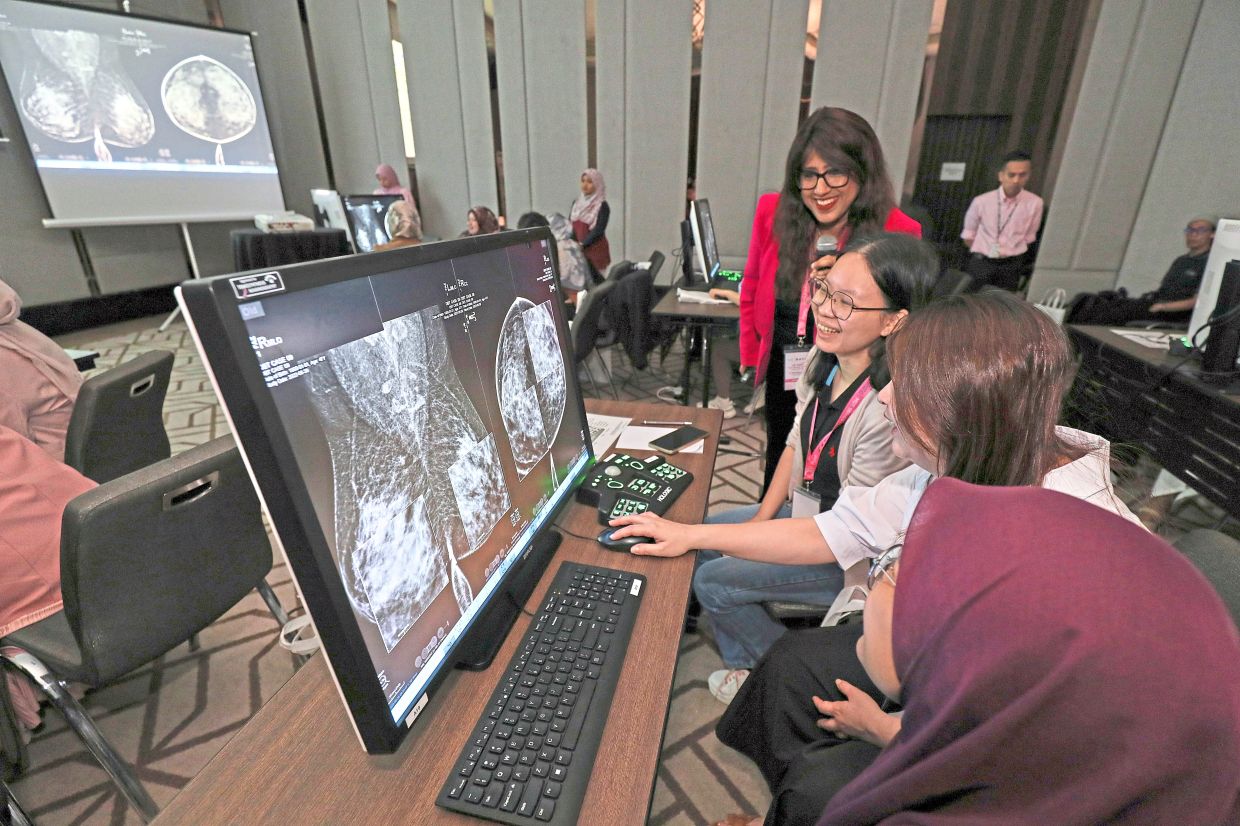 Radiologists take part in a hands-on workshop, reviewing breast imaging cases using 2D mammography, 3D digital breast tomosynthesis and contrast-enhanced mammography to strengthen their interpretation of breast imaging findings. — YAP CHEE HONG/The Star