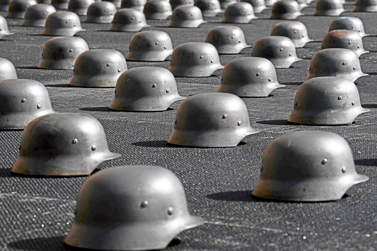 To create the installation, Ai employed artisans in a Chinese foundry to produce hundreds of iron sculptures based on various 20th-century combat helmets. Photo: AFP