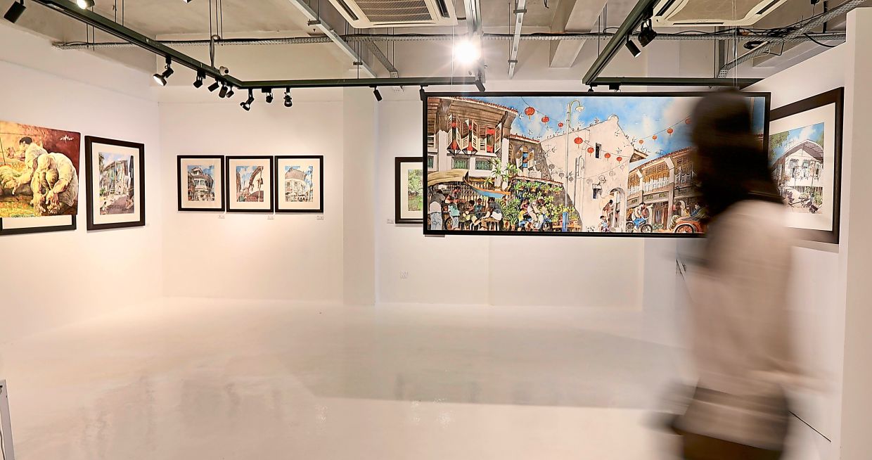 Lee’s paintings traverse old shophouses, back lanes, roadside stalls and familiar corners of George Town. Photo: The Star/Low Lay Phon