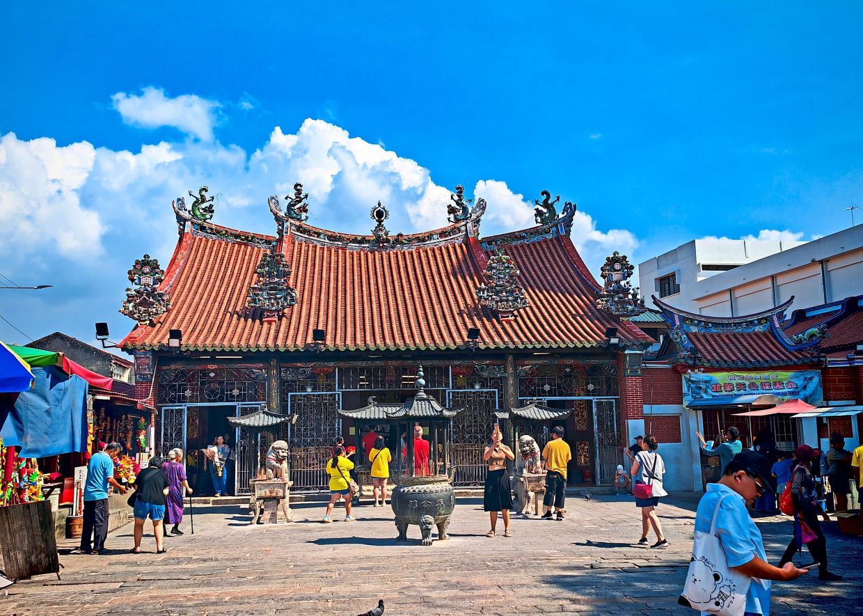 People offering prayers at the Goddess of Mercy Temple in Jalan Masjid Kapitan Keling.