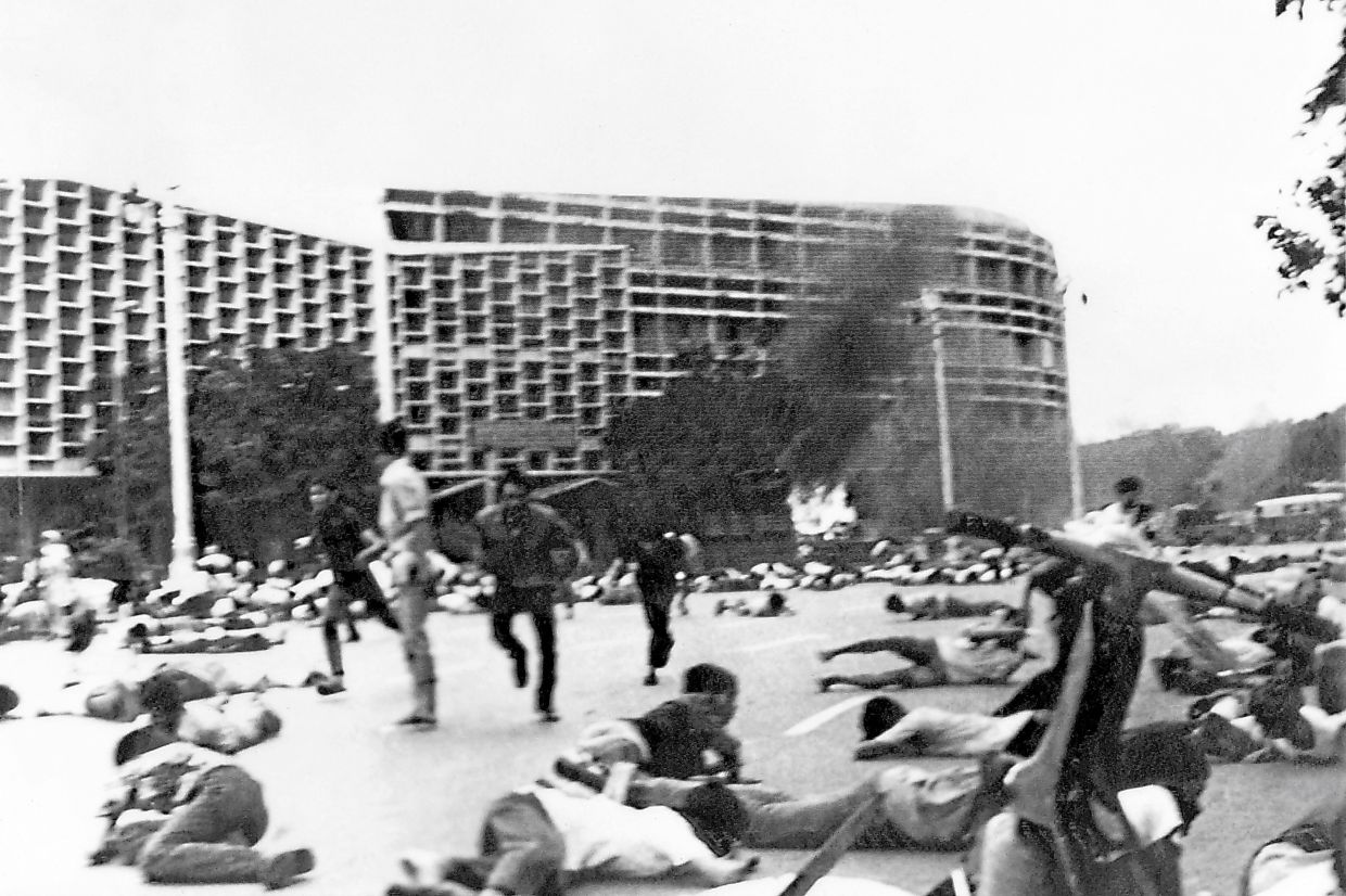 Past horrors: A file photo showing students reacting as shots are fired at Thammasat University on Oct 6, 1976, as numerous students were killed and others injured during violent demonstrations. — AFP