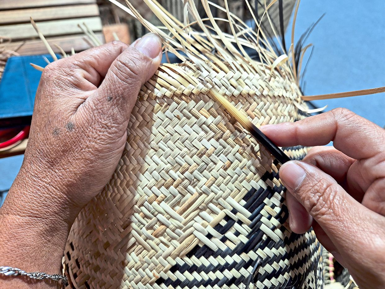 Weaving rattan by hand is painstaking work, requiring patience and skill.