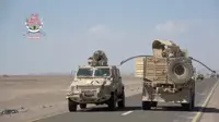 Yemeni government fighters shown driving vehicles over Houthi opponents