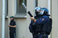 France suspends use of stun grenades to police student protests