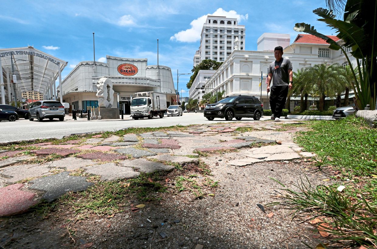 A view of uneven footpath along Lebuh Farquhar that will be upgraded under a RM433,000 project. — ZHAFARAN NASIB/The Star 