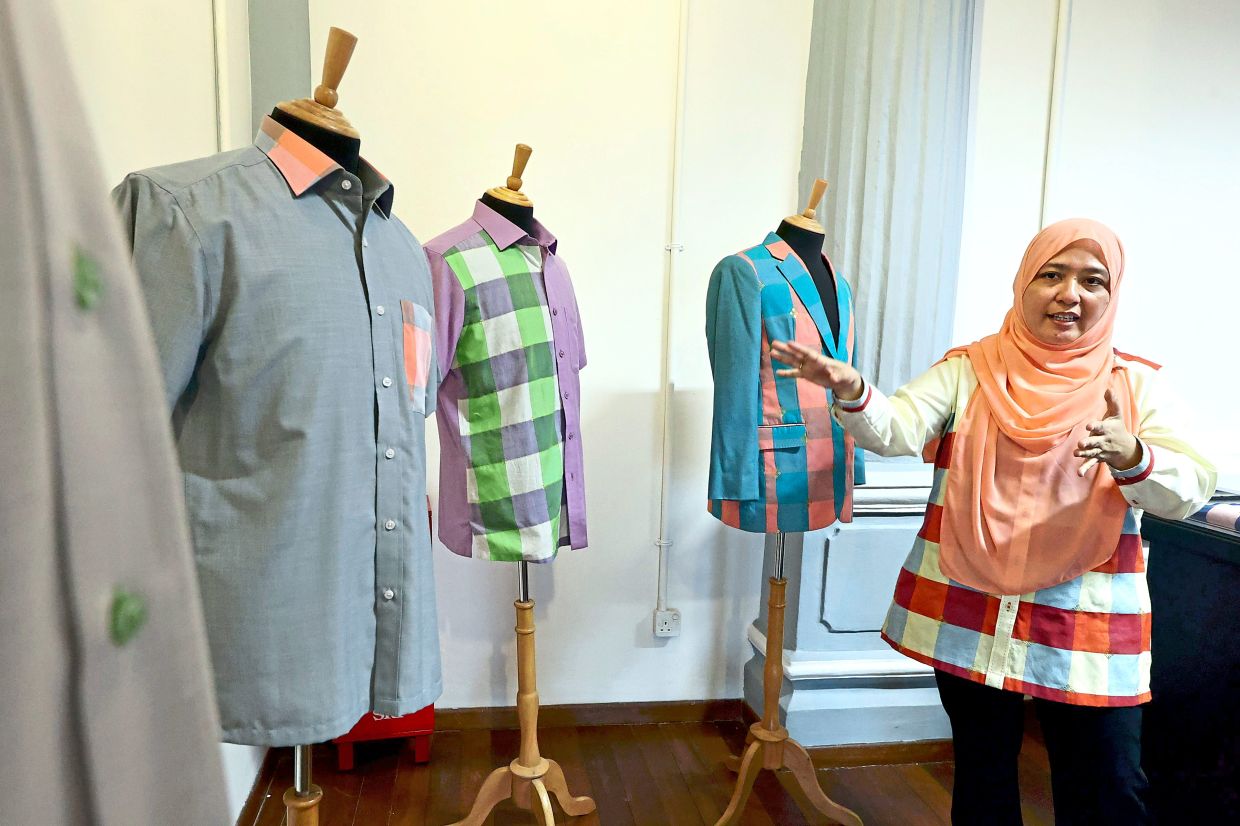 Roslinda explaining how Kain Benang Johor can be made into modern and contemporary clothing such as shirts.