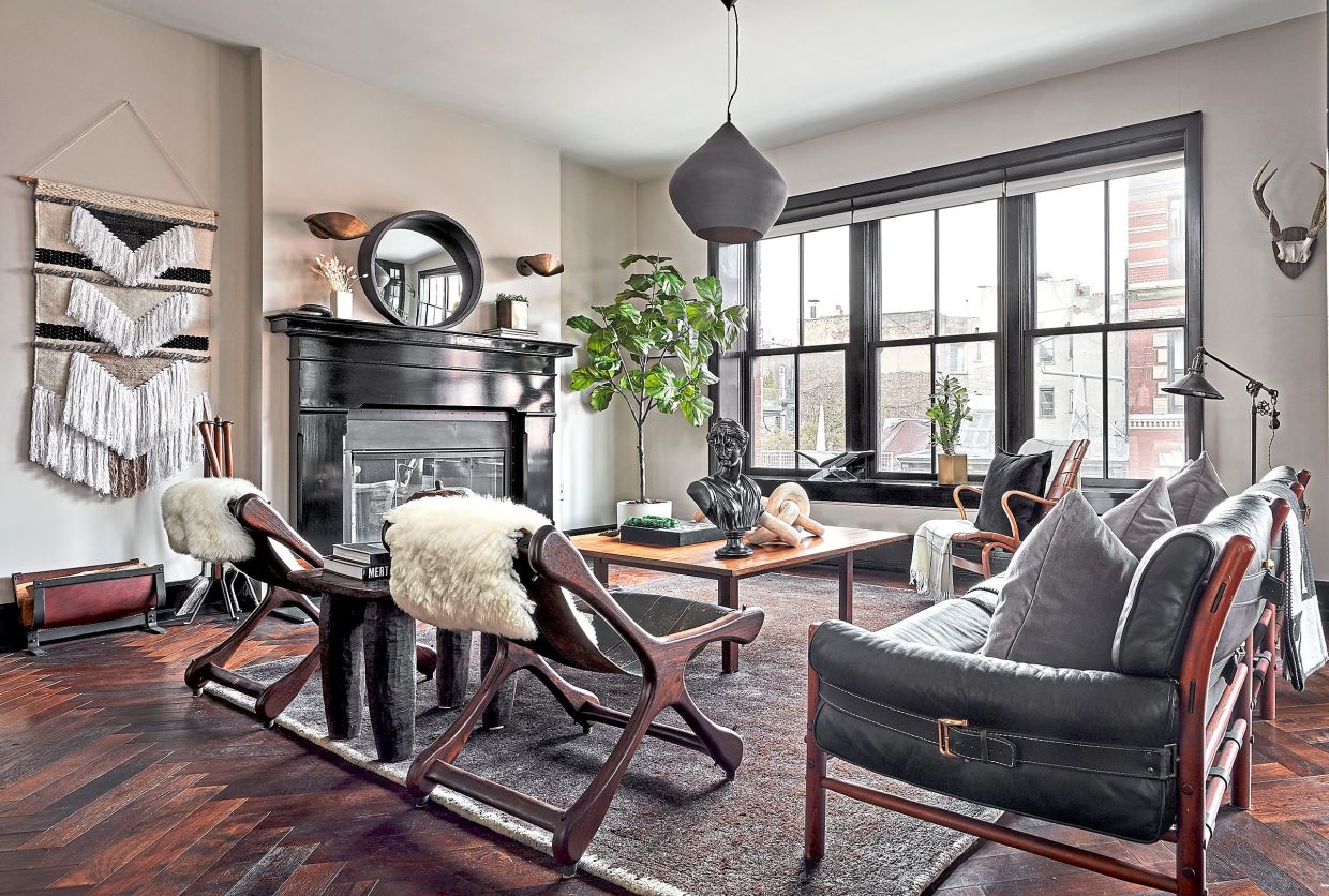 A chandelier with metallic tones helps to create a modern vibe in this living space.