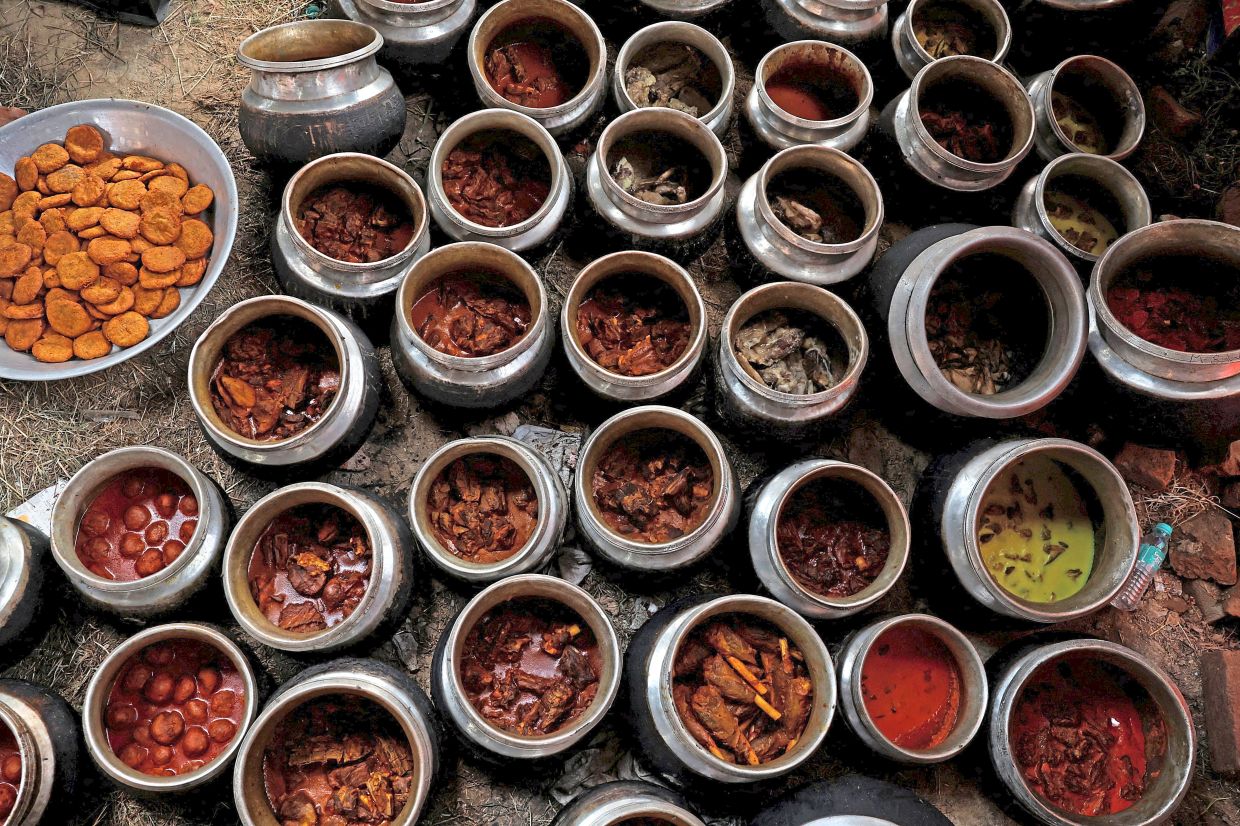 Degchis or traditional cooking pots filled with Kashmiri Wazwan dishes ready to be served at a wedding in Srinagar.