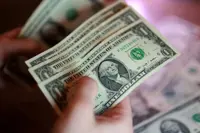Dollar edges back from 18-month high after FOMC minutes