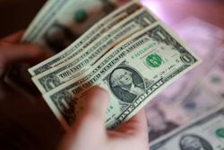 Dollar edges back from 18-month high after FOMC minutes
