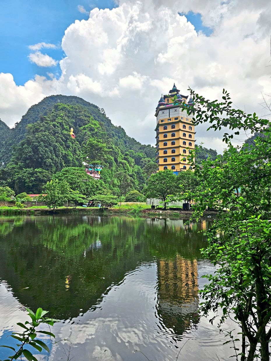 The pagoda is reflected on the pond in front of the building.