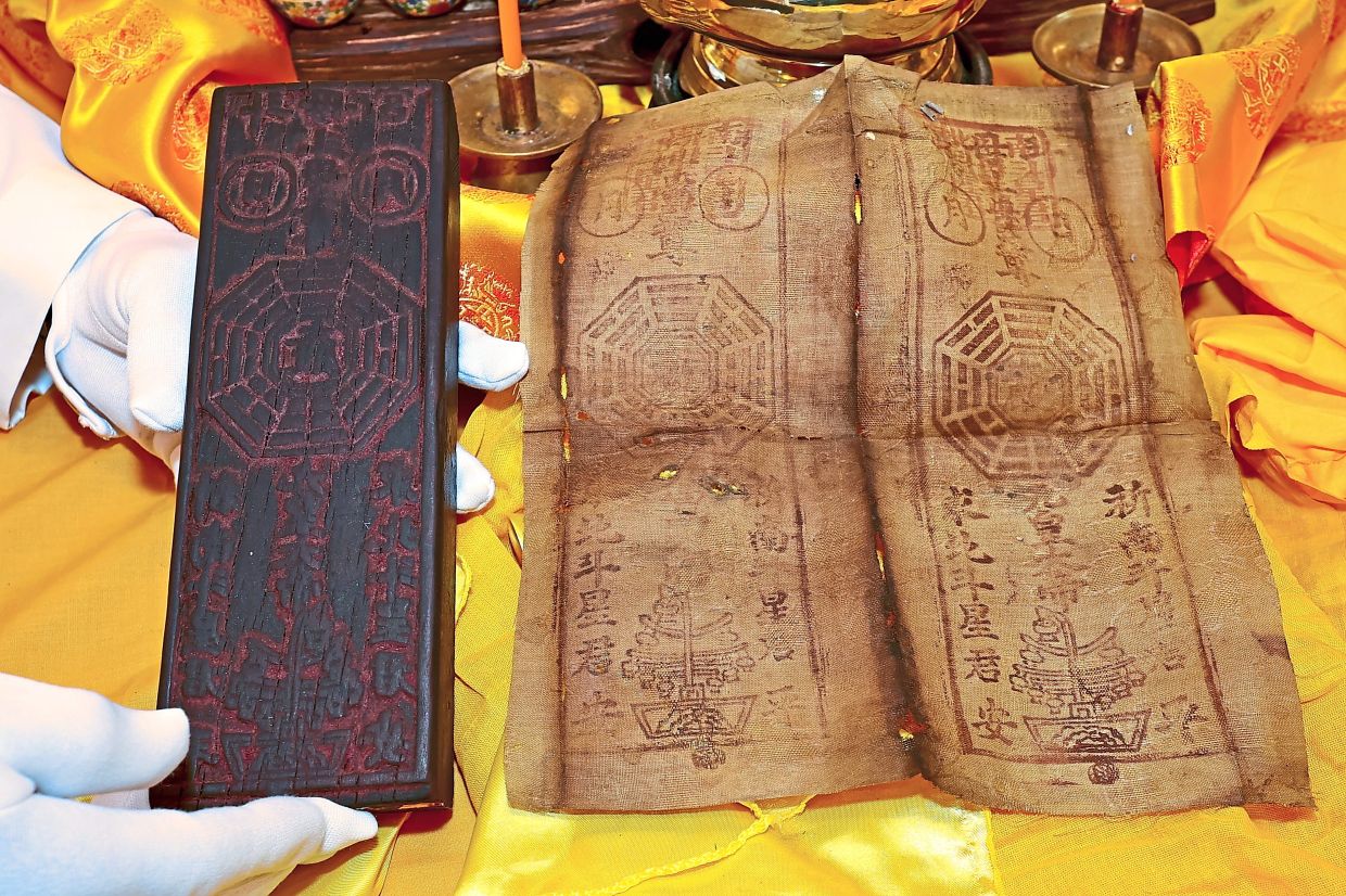 Ink across ages: The wooden seal used to stamp the cloth talisman on display at the Hong Kong Street Tow Boh Keong Temple.