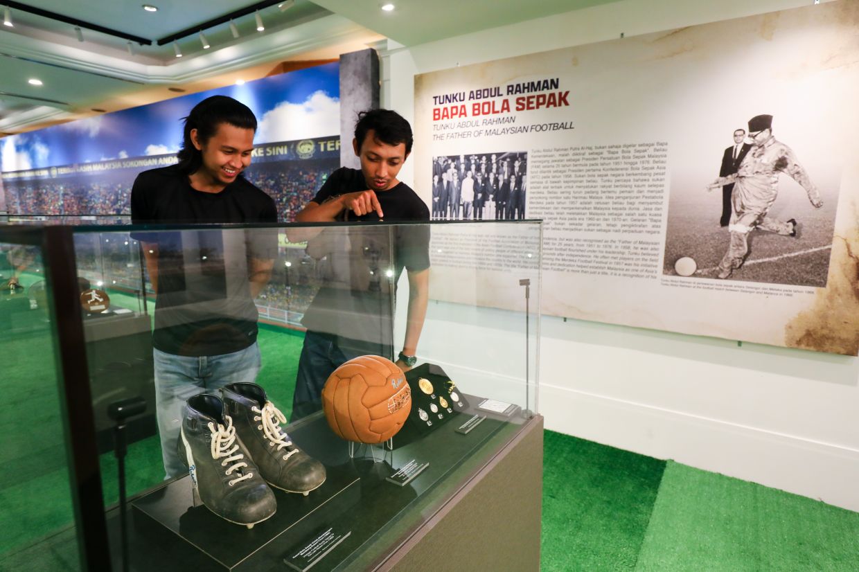 A pair of boots and a football signed by Malaysian football great Robert Choe are among the exhibits of 'Bola Merdeka' at Muzium Negara in KL. Choe helped secure three consecutive Merdeka Tournament titles from 1958 to 1960, when the competition attracted leading teams from across Asia. Photo: The Star/Leong Wai Yee 