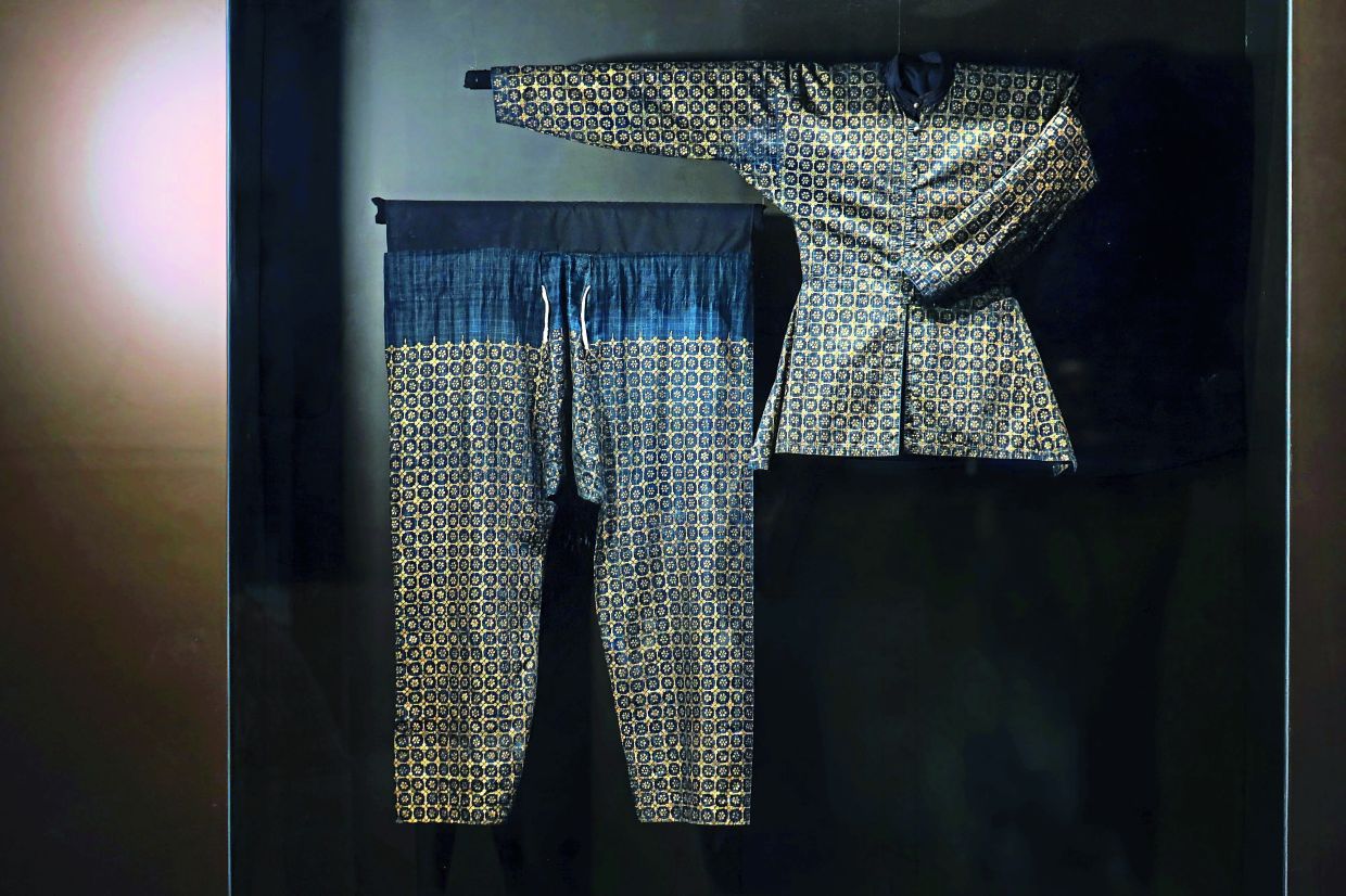 Mid-19th century royal coat, or Baju Sikap, associated with Sultan Sir Abdul Samad. Dating back more than 170 years, the garment offers visitors a direct look at how gilded textiles functioned in court attire.