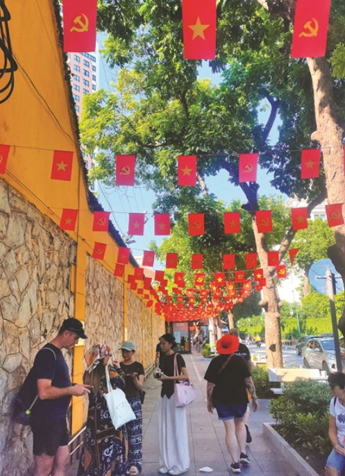 A street is decorated with flags to mark the occasion. - Vietnam News/ANN