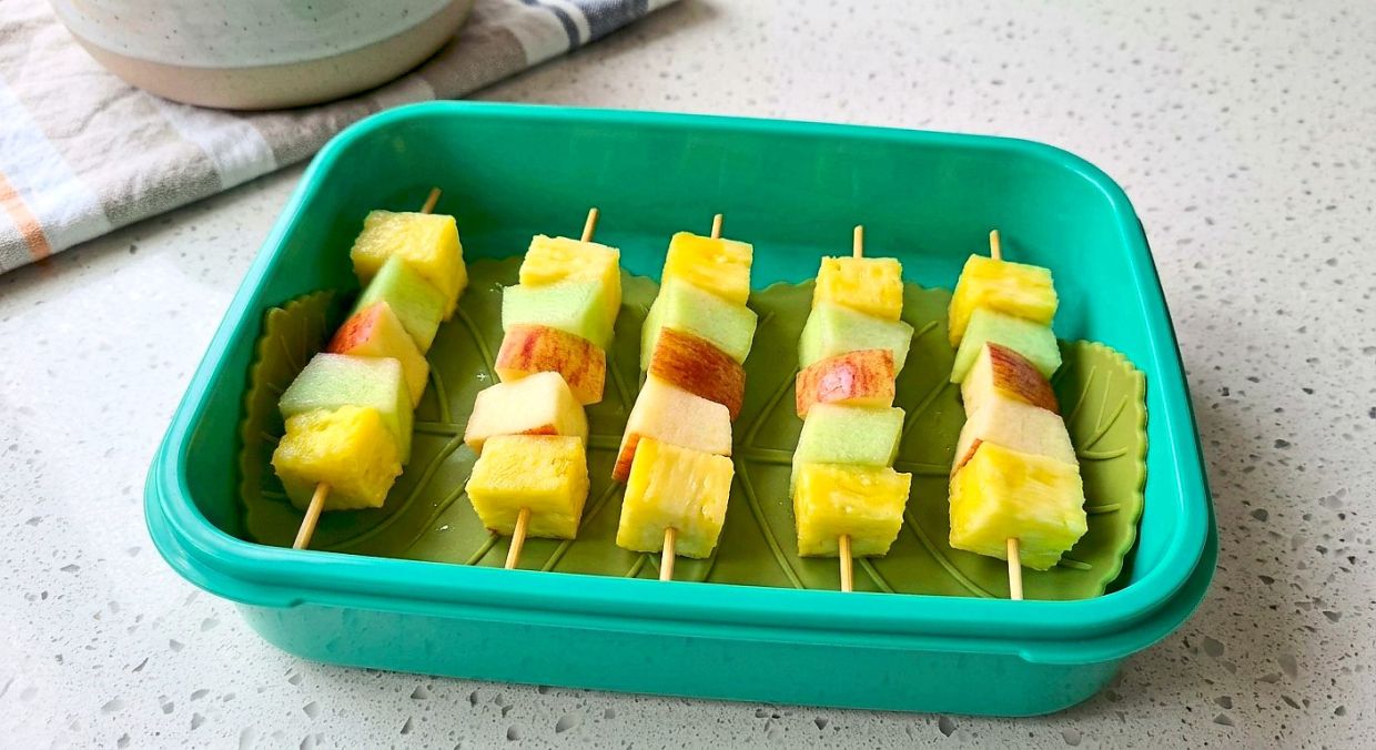 Get creative with fruits by cutting them up and sticking them on skewers. (This visual is human-created, AI-aided)