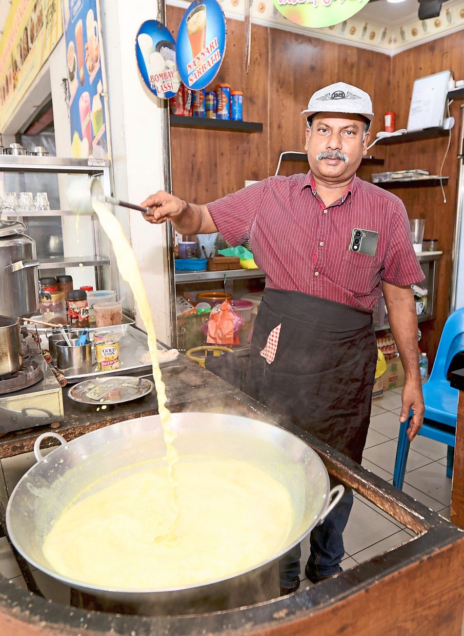 Mahalingam making the popular almond milk drink sold at his stall in the Tun Sambanthan Complex food court.