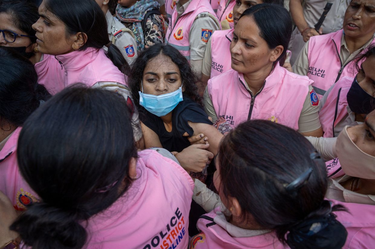A protester is detained by security personnel during a protest by the Cockroach Janta Party (CJP) seeking the resignation of India's Chief Election Commissioner, Gyanesh Kumar, near the protest site in New Delhi, India, on Saturday, October 10, 2026. -- Photo: REUTERS/Adnan Abidi