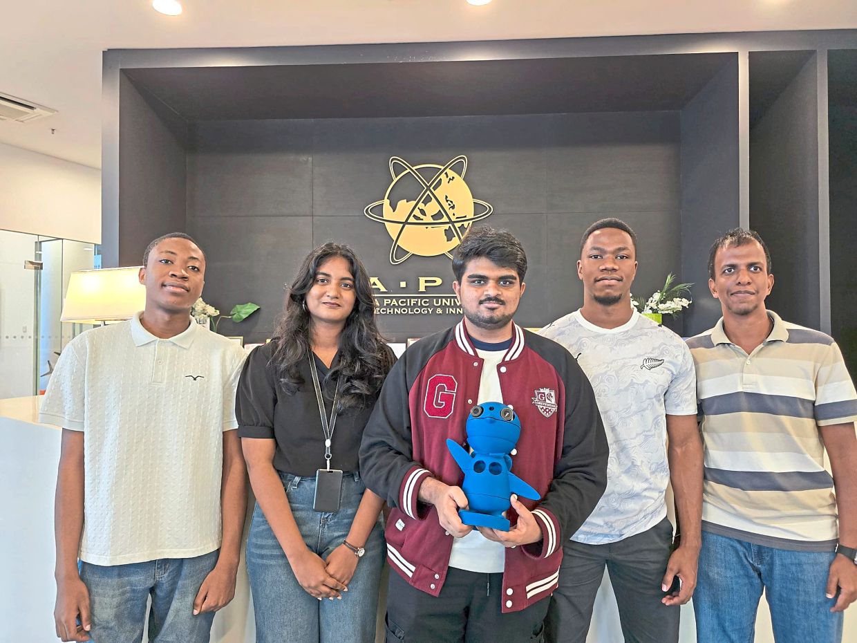 Smart screening: The APU team behind the contactless vital sign screening device, designed in the form of a penguin to create a more child-friendly experience.