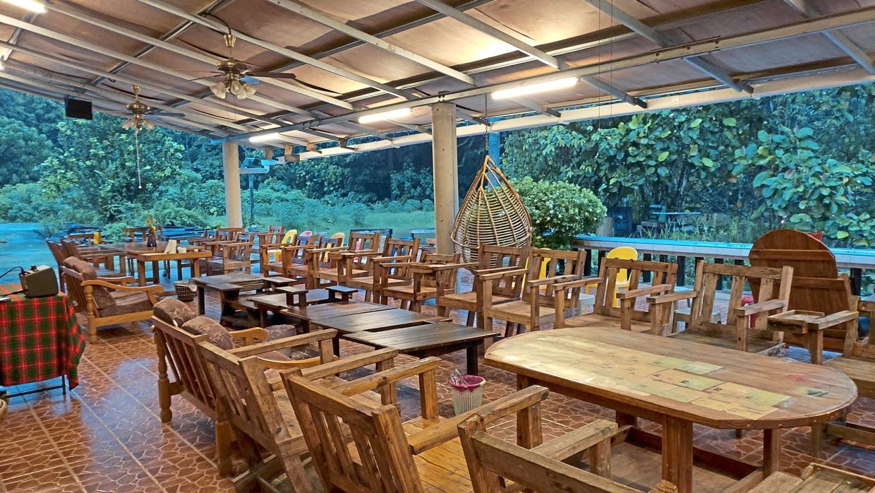 An open-air gathering space offers guests a place to dine, unwind and enjoy the peaceful surroundings, with every piece of furniture designed and made by Seminar using reclaimed wood.
