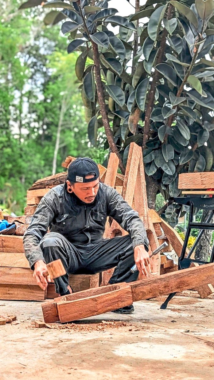 Gindung with a partly completed sundatang as he works to preserve the traditional Sabah instrument.