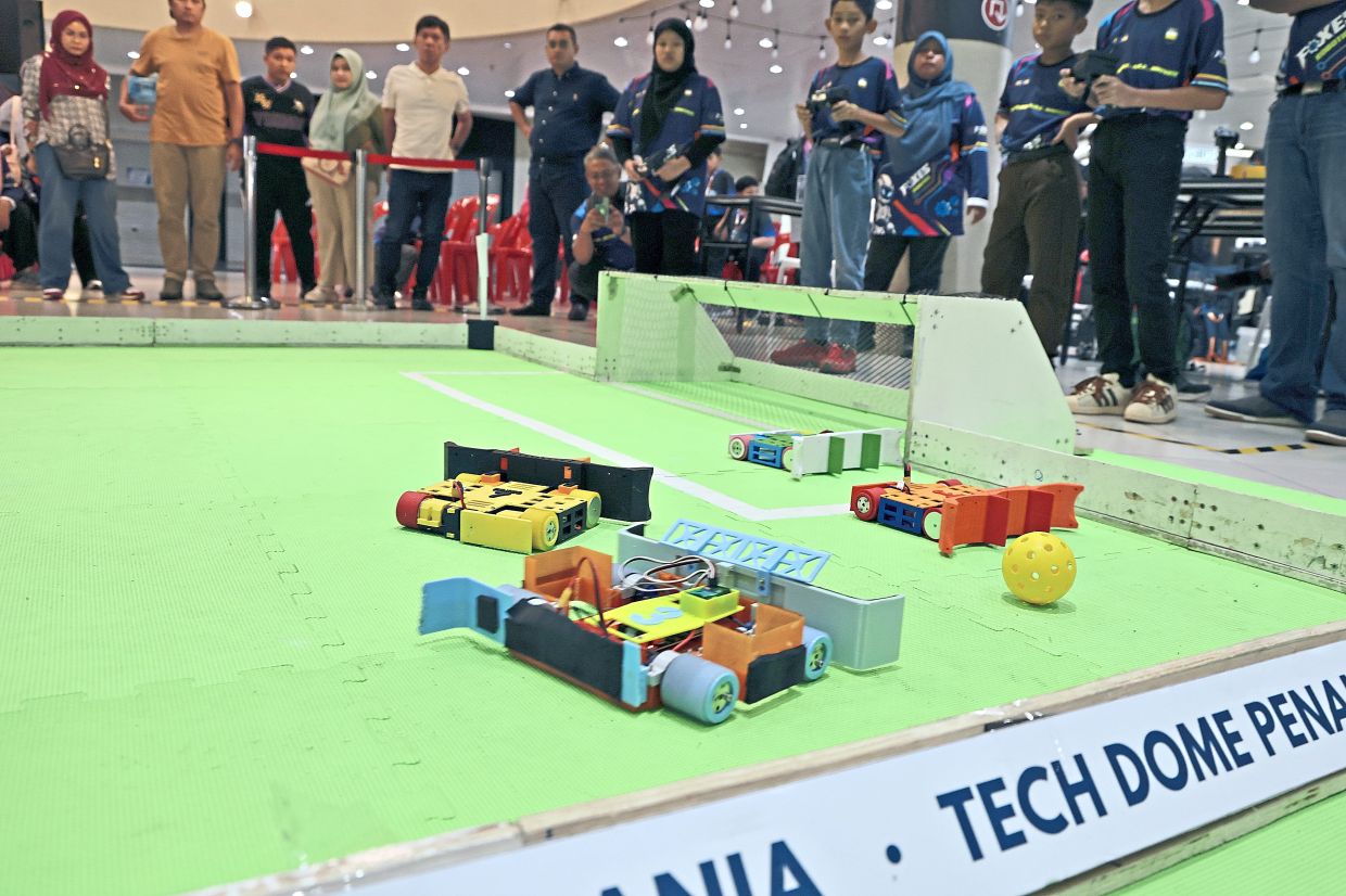 Participants taking on the robot football tournament that gives students hands-on experience in engineering, robot design and teamwork.