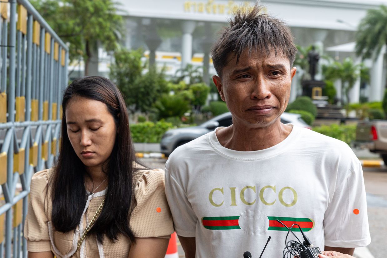 Tongchai Donhomla (right), father of a teenage girl whose body was found in a suitcase, with Miruntree Thanachai, her aunt, cries as he talks to reporters outside Pattaya Provincial Court in Pattaya, Thailand, on Monday, Oct. 12, 2026. -- AP Photo/Wason Wanichakorn